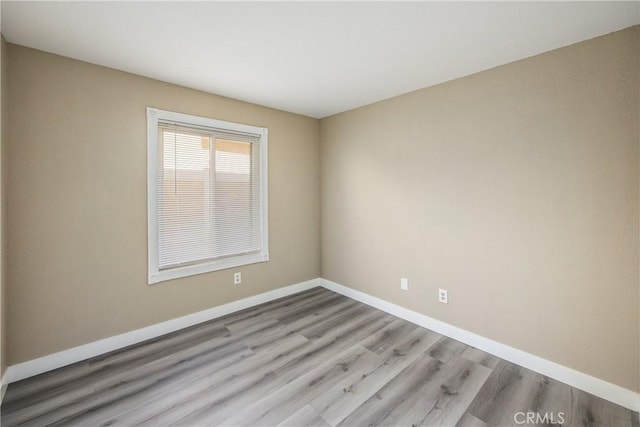 empty room with light hardwood / wood-style flooring