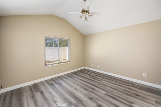 unfurnished room with lofted ceiling, light hardwood / wood-style floors, and ceiling fan