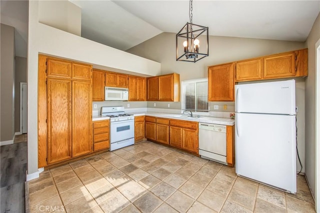 kitchen featuring sink, a chandelier, high vaulted ceiling, hanging light fixtures, and white appliances