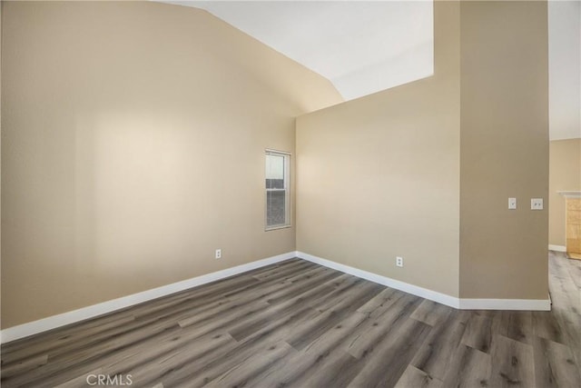 unfurnished room with wood-type flooring and lofted ceiling