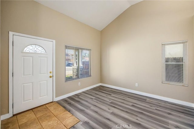 entrance foyer featuring high vaulted ceiling and light hardwood / wood-style floors