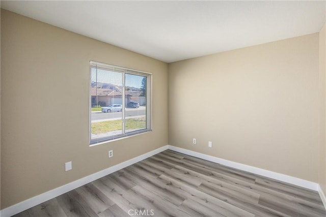 spare room with light wood-type flooring