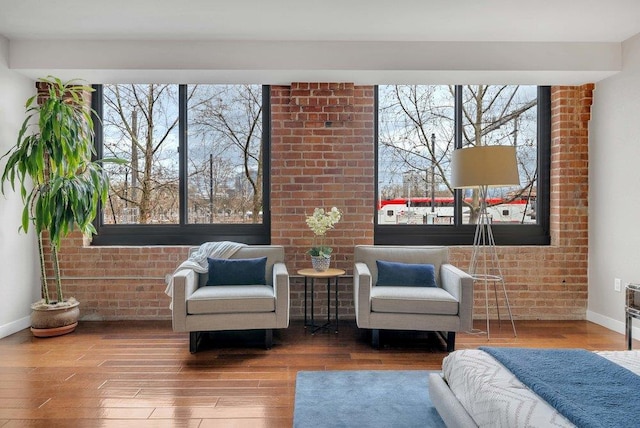 sitting room featuring plenty of natural light and hardwood / wood-style floors