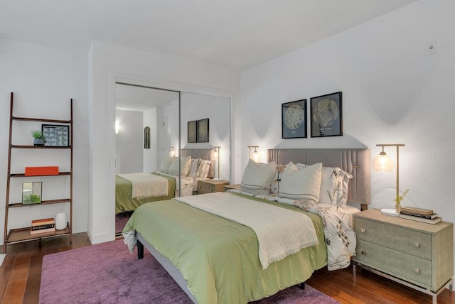 bedroom with a closet and dark hardwood / wood-style flooring