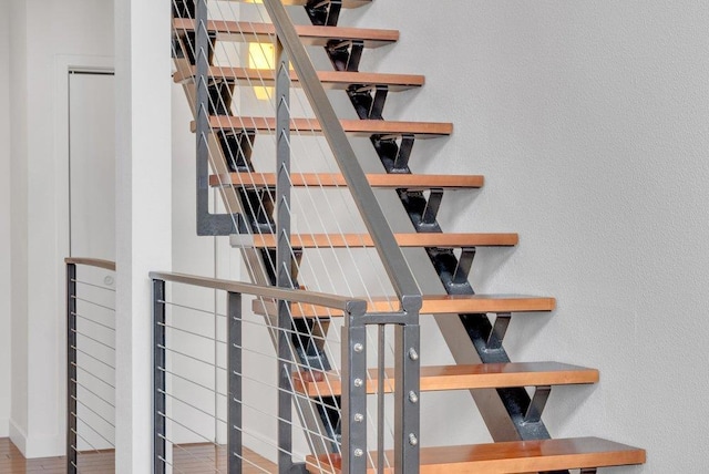 stairs with hardwood / wood-style floors