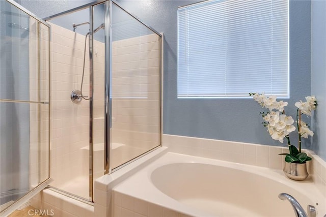 full bath featuring a bath and a stall shower