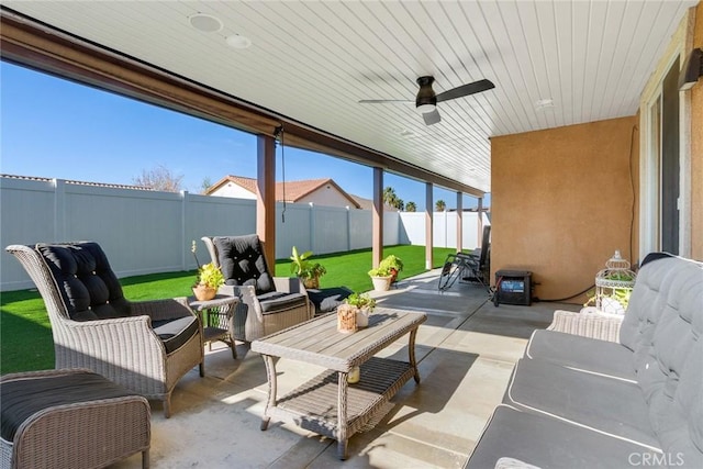 view of patio / terrace featuring a fenced backyard, ceiling fan, and outdoor lounge area