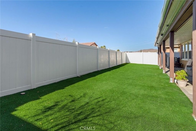 view of yard with a fenced backyard