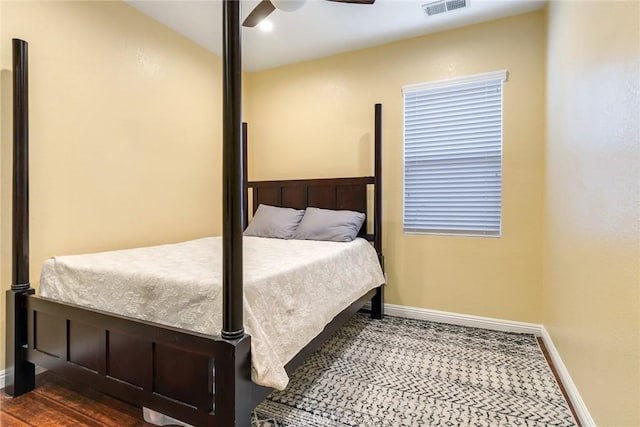 bedroom with ceiling fan and dark hardwood / wood-style flooring