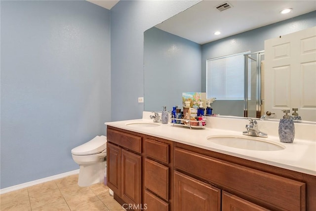 bathroom with toilet, vanity, tile patterned flooring, and a shower with door