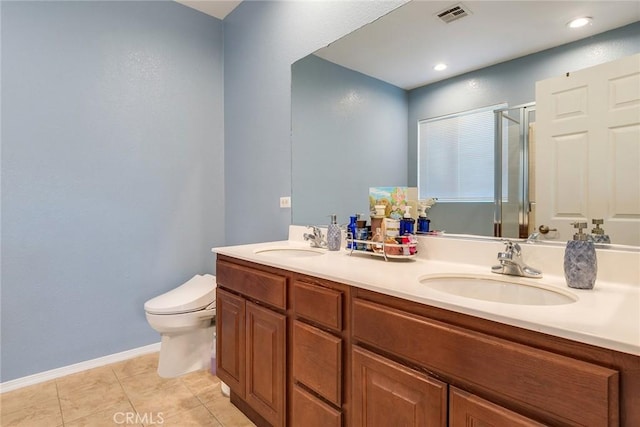 bathroom featuring toilet, visible vents, a sink, and a stall shower