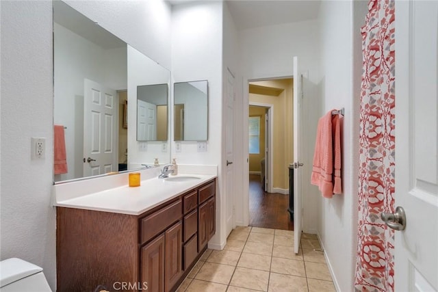 bathroom featuring tile patterned floors, vanity, and toilet