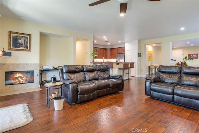 living area featuring recessed lighting, wood-type flooring, a fireplace, and ceiling fan