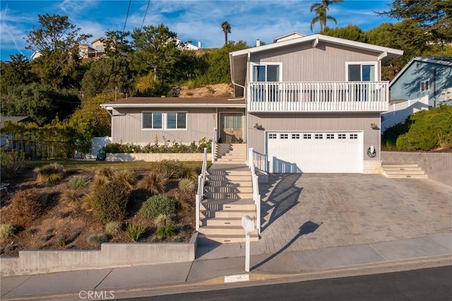 view of front of home with a garage and a balcony