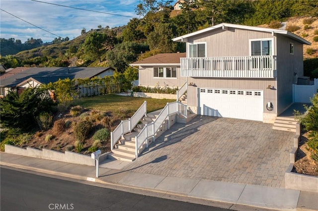 view of front facade featuring a balcony and a garage