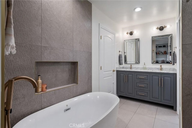 bathroom with vanity, tile patterned flooring, and a washtub