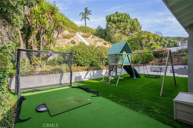 view of jungle gym featuring a lawn