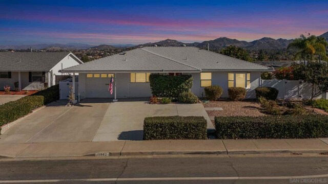 single story home featuring a garage and a mountain view