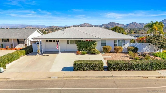 single story home with a garage and a mountain view