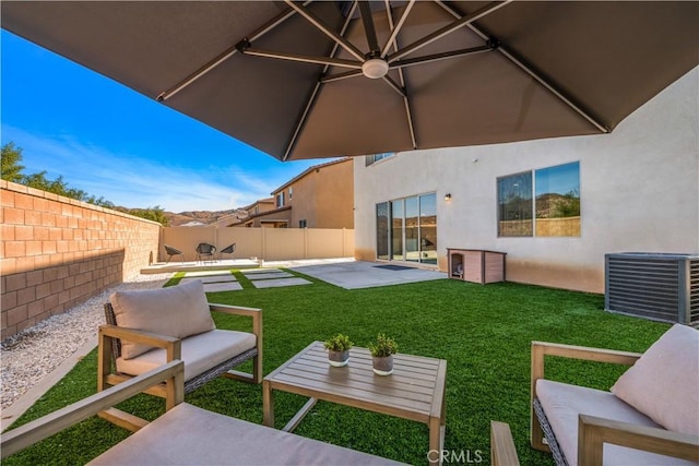 exterior space featuring central AC, a lawn, and a patio