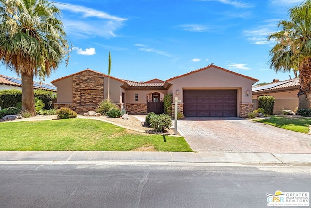 view of front of home with a garage and a front lawn