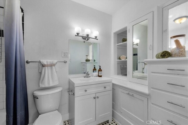 bathroom featuring toilet and vanity