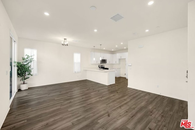 unfurnished living room with dark hardwood / wood-style floors