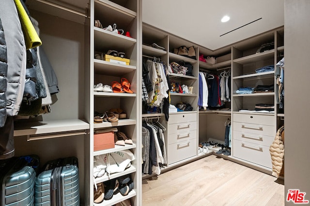 spacious closet featuring light hardwood / wood-style floors