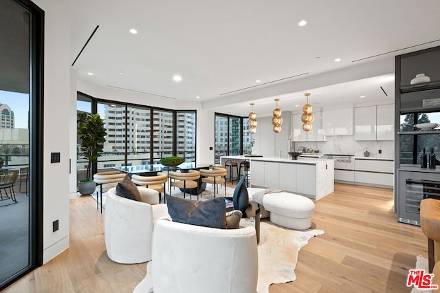 living room with wine cooler and light wood-type flooring