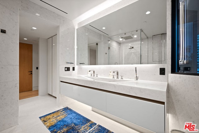 bathroom with walk in shower and vanity