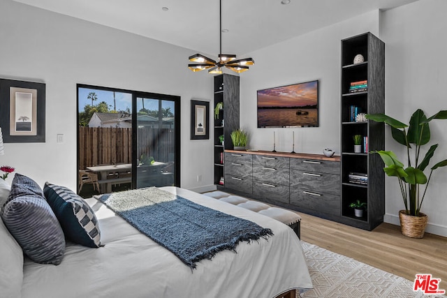 bedroom featuring light hardwood / wood-style flooring and a notable chandelier