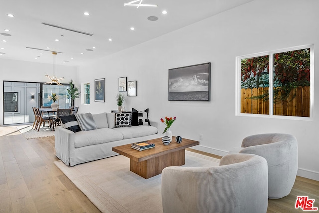 living room with plenty of natural light and light hardwood / wood-style floors