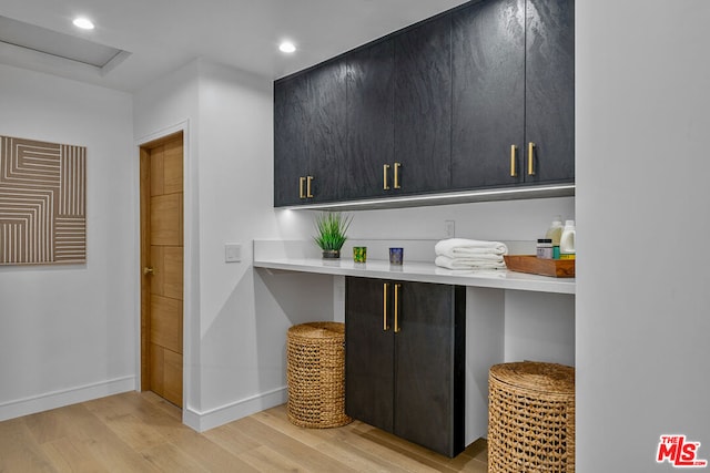 kitchen with a breakfast bar, kitchen peninsula, and light hardwood / wood-style flooring