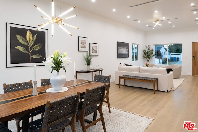 dining room with a notable chandelier and light wood-type flooring