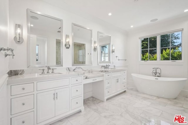 bathroom with a washtub and vanity