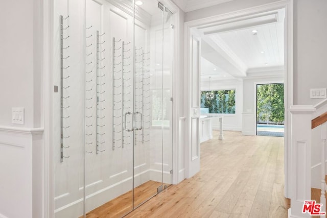 interior space featuring light wood-type flooring and crown molding