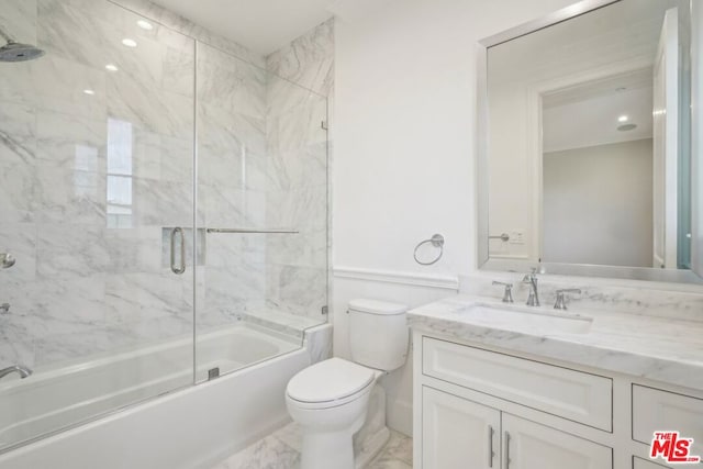 full bathroom with enclosed tub / shower combo, vanity, and toilet