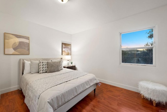 bedroom with hardwood / wood-style flooring