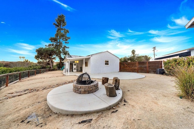 back of property featuring a patio area and an outdoor fire pit