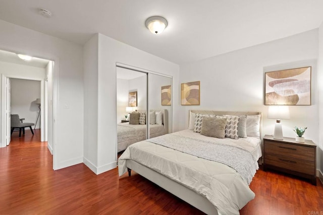 bedroom featuring dark hardwood / wood-style floors and a closet