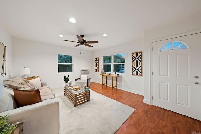 living room featuring ceiling fan and wood-type flooring