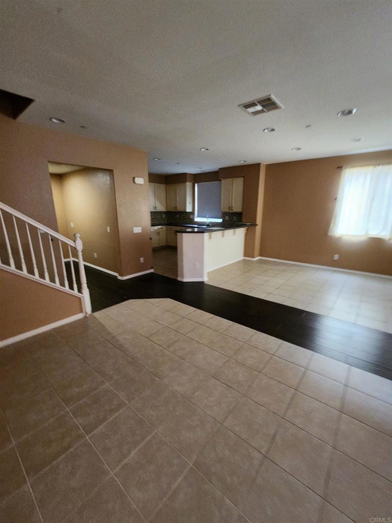 unfurnished living room with light tile patterned flooring