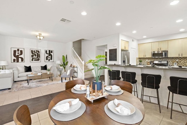 dining area featuring light tile patterned flooring