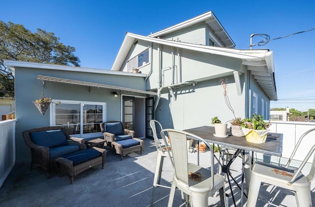 rear view of house featuring outdoor lounge area and a patio area