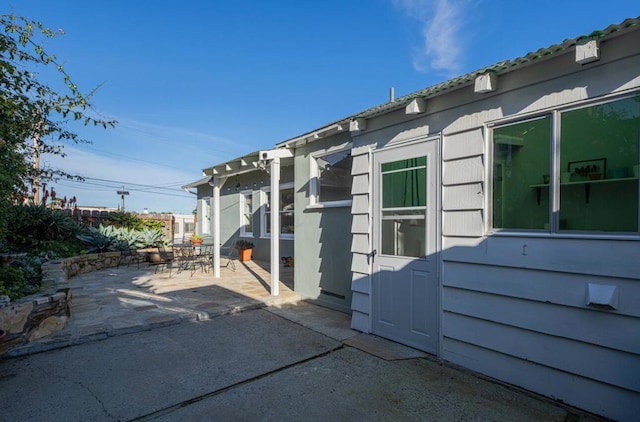 view of side of property with a patio