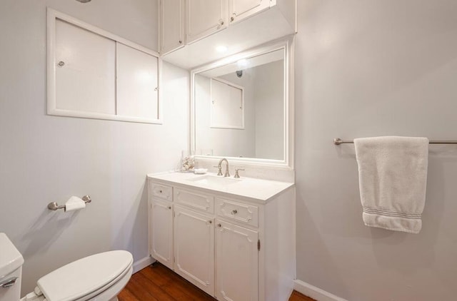 bathroom with vanity, hardwood / wood-style floors, and toilet