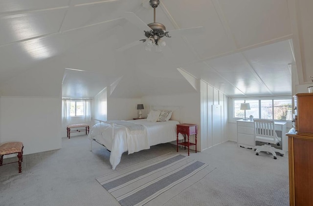 carpeted bedroom featuring ceiling fan, vaulted ceiling, and multiple windows