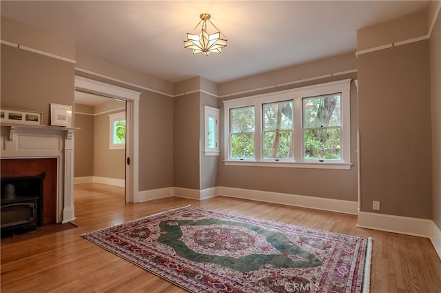 living room with a wood stove and hardwood / wood-style flooring