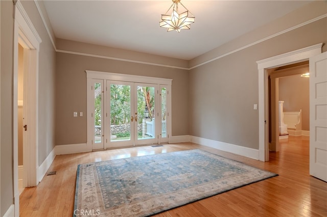 doorway to outside with light hardwood / wood-style floors and french doors