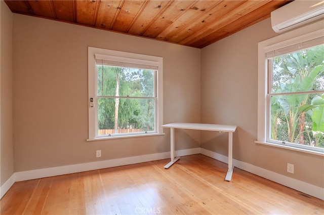 spare room with light hardwood / wood-style floors and a wall mounted air conditioner